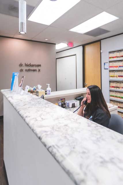 Receptionist talking on the phone at Hickerson & Associates, DDS. PC. in Houston, TX